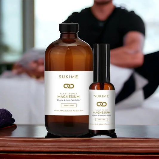 Sukime vegan magnesium oil in amber glass bottles with man giving massage in background