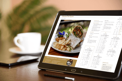 Bali Vegan e-Book on ipad siting on wood table with pen and coffee cup. 